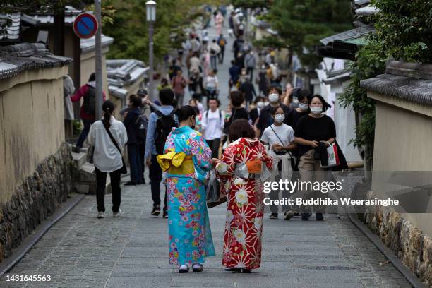 Tourists dressed in traditional Japanese outfits walk to Kiyomizu Temple, one of Japan's most popular tourist destinations on October 08, 2022 in...