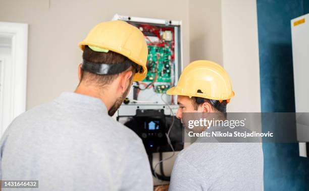 workers checks the air conditioner - art installation stock pictures, royalty-free photos & images