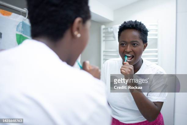 happy woman brushing teeth - image technique stock pictures, royalty-free photos & images