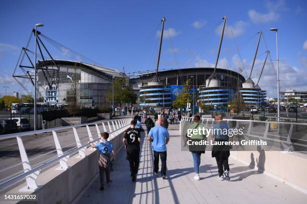 Fans arrive outside the stadium prior to the Premier League match between Manchester City and Southampton FC at Etihad Stadium on October 08, 2022 in...