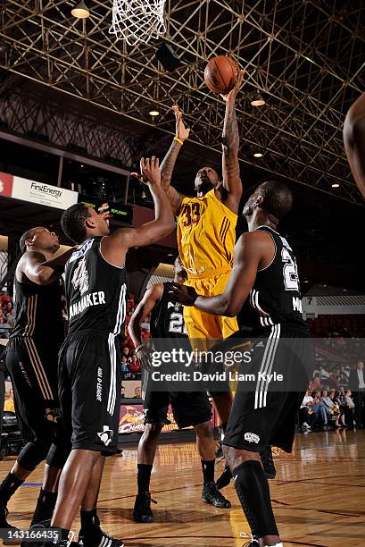 Frank Hassell of the Canton Charge tosses up the shot against Brad Wanamaker and Ronald Murray of the Austin Toros at the Canton Memorial Civic...