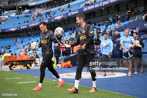 Ederson and Scott Carson of Manchester City enter the pitch to warm up prior to the Premier League match between Manchester City and Southampton FC...