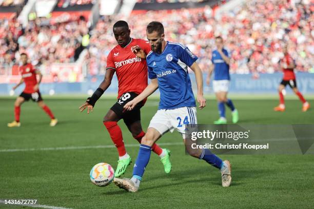 Moussa Diaby of Bayer 04 Leverkusen challenges Dominick Drexler of FC Schalke 04 during the Bundesliga match between Bayer 04 Leverkusen and FC...