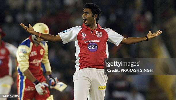 Kings XI Punjab bowler Parvinder Awana celebrates taking the wicket of Royal Challengers Bangalore batsman Mayank Agarwal during the IPL Twenty20...