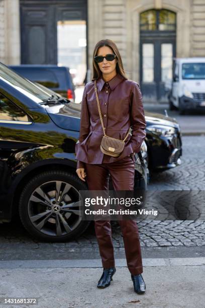 Guest wears blazer, cropped top, bag, red leather pants &outside Chanel during Paris Fashion Week - Womenswear Spring/Summer 2023 : Day Nine on...