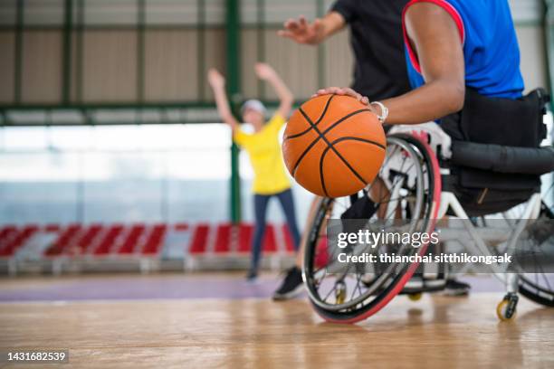 disabled sport men in action while playing  basketball at court. - wheelchair race stock pictures, royalty-free photos & images