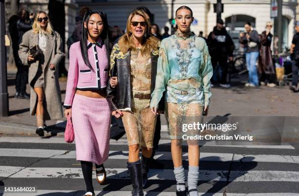 Koral Madi wears pink black button up jacket with pockets, skirt, rose bag, brown white loafers tights & Anna dello Russo wears see trough beige...