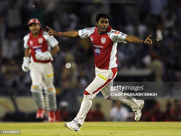 Kings XI Punjab bowler Parvinder Awana celebrates taking the wicket of Royal Challengers Bangalore batsman Virat Kohli during the IPL Twenty20...