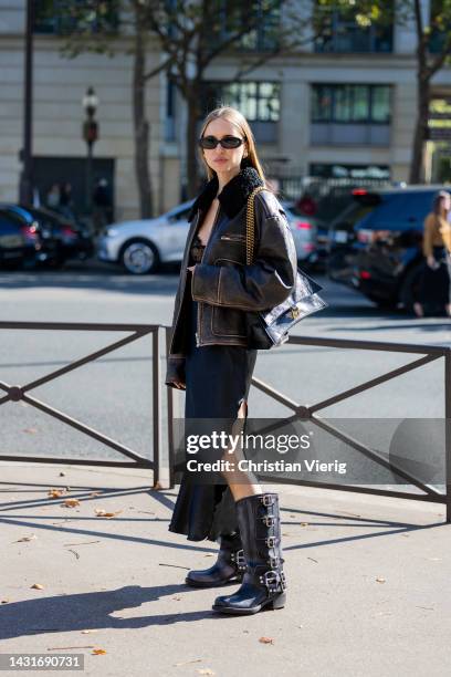 Pernille Teisbaeck wears shearling brown black jacket, black silk dress with lace top, Balenciaga bag outside Miu Miu during Paris Fashion Week -...