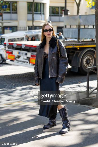 Pernille Teisbaeck wears shearling brown black jacket, black silk dress with lace top, Balenciaga bag outside Miu Miu during Paris Fashion Week -...