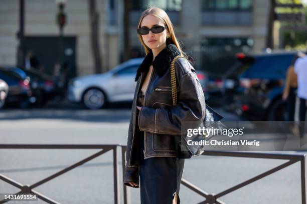 Pernille Teisbaeck wears shearling brown black jacket, black silk dress with lace top, Balenciaga bag outside Miu Miu during Paris Fashion Week -...