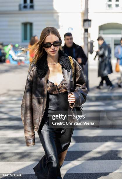 Pernille Teisbaeck wears shearling brown black jacket, black silk dress with lace top, Balenciaga bag outside Miu Miu during Paris Fashion Week -...