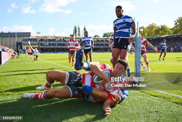 Louis Rees-Zammit of Gloucester is tackled by Cameron Redpath of Bath during the Gallagher Premiership Rugby match between Bath Rugby and Gloucester...