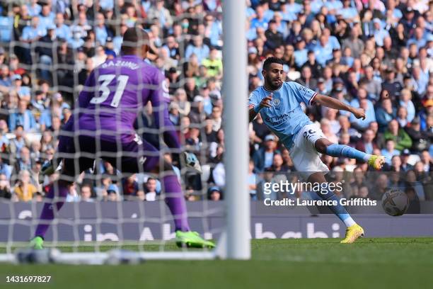 Riyad Mahrez of Manchester City scores their team's third goal past Gavin Bazunu of Southampton during the Premier League match between Manchester...