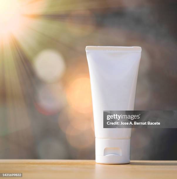 tube of sunscreen moisturizer cream illuminated by sunlight. - hair conditioner stock pictures, royalty-free photos & images