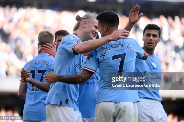 Erling Haaland celebrates with Joao Cancelo of Manchester City after scoring their team's fourth goal during the Premier League match between...