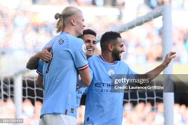 Erling Haaland of Manchester City celebrates with teammates after scoring their team's fourth goal during the Premier League match between Manchester...