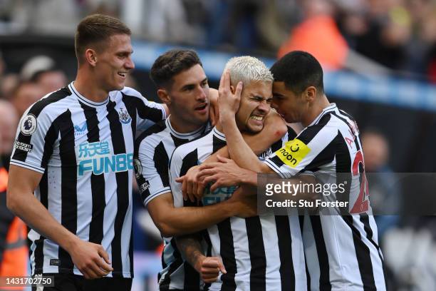 Bruno Guimaraes of Newcastle United celebrates with teammates after scoring their team's third goal during the Premier League match between Newcastle...