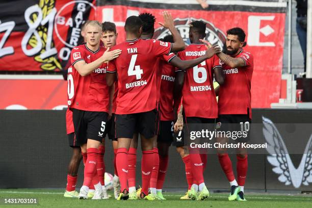 Paulinho of Bayer 04 Leverkusen celebrates scoring their side's fourth goal with teammates during the Bundesliga match between Bayer 04 Leverkusen...