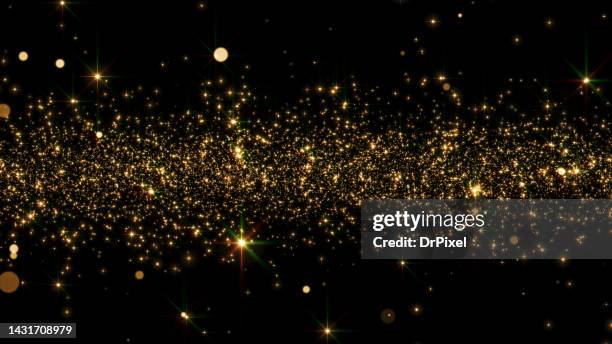 shiny golden particles - glowing star stock pictures, royalty-free photos & images