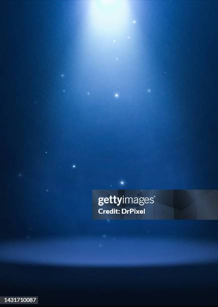 blue spotlight with particles illuminating the stage - stage light 3d stock pictures, royalty-free photos & images