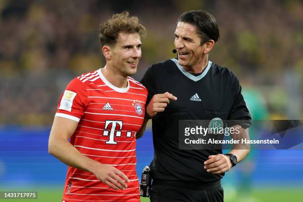Referee Deniz Aytekin looks on with Leon Goretzka of Bayern Munich during the Bundesliga match between Borussia Dortmund and FC Bayern Muenchen at...