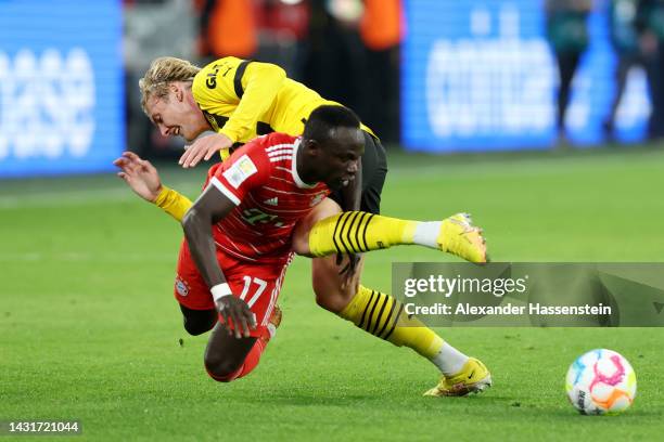 Sadio Mane of Bayern Munich is challenged by Julian Brandt of Borussia Dortmund during the Bundesliga match between Borussia Dortmund and FC Bayern...