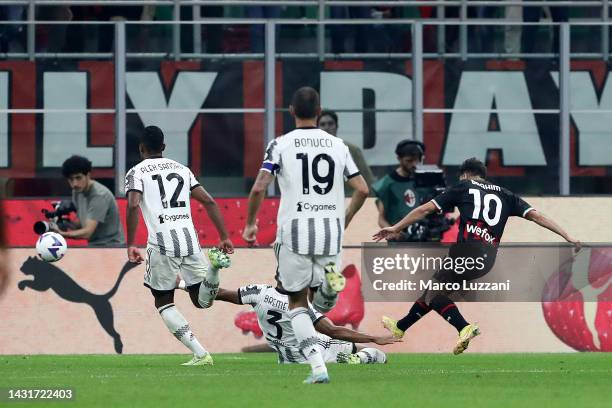 Brahim Diaz of AC Milan scores their side's second goal whilst under pressure from Bremer of Juventus during the Serie A match between AC Milan and...