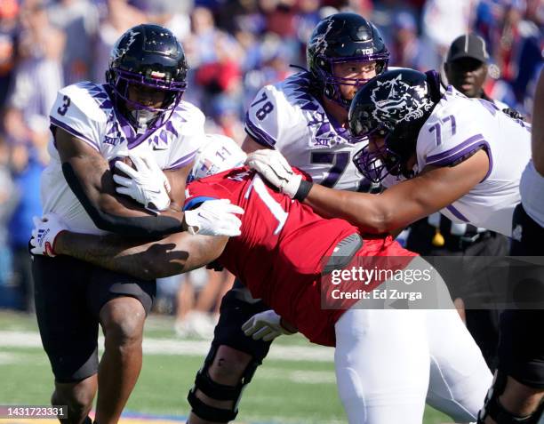 Running back Emari Demercado of the TCU Horned Frogs rushes against defensive lineman Eddie Wilson of the Kansas Jayhawks in the first half at David...