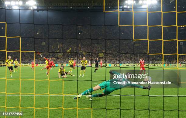 Leroy Sane of Bayern Munich scores their team's second goal past Alexander Meyer of Borussia Dortmund during the Bundesliga match between Borussia...