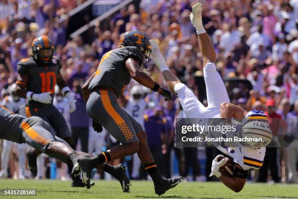 Mason Taylor of the LSU Tigers is tackled by Trevon Flowers of the Tennessee Volunteers during the first half a game at Tiger Stadium on October 08,...