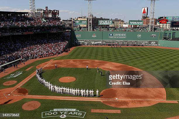 The New York Yankees and the Boston Red Sox line up on the field in celebration of Fenway Park's 100 years before the game on April 20, 2012 at...