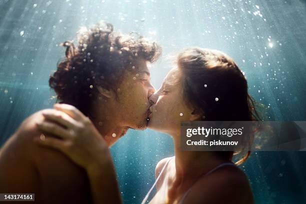 happy couple underwater - peck stock pictures, royalty-free photos & images