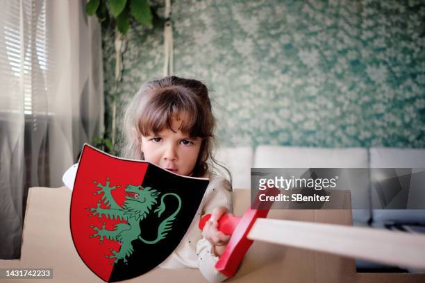 girl playing with shield and sword - wooden shield stock pictures, royalty-free photos & images