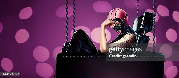 fetish woman in leather sofa - fetisj stock pictures, royalty-free photos & images