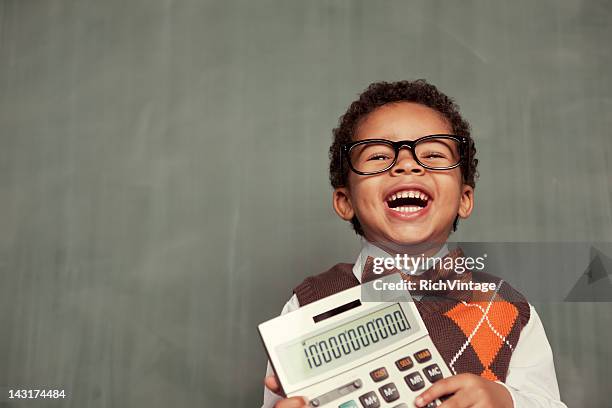 young nerd boy wearing glasses holding calculator - classroom and math stock pictures, royalty-free photos & images
