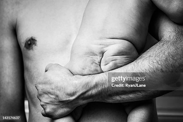 baby bottom in fathers arms - boys bare bum stock pictures, royalty-free photos & images