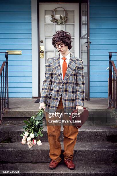 sad nerd with valentine gift and flowers on front porch - unwanted present stock pictures, royalty-free photos & images