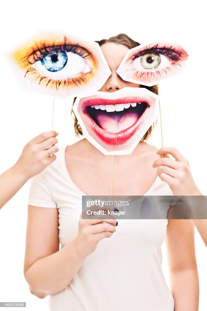 Woman with eyes and smile signs infront of her