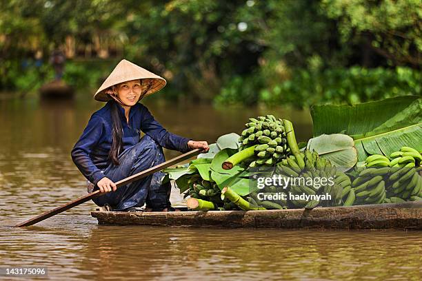 donna vietnamita canottaggio barca al fiume mekong delta, vietnam - fiume mekong foto e immagini stock