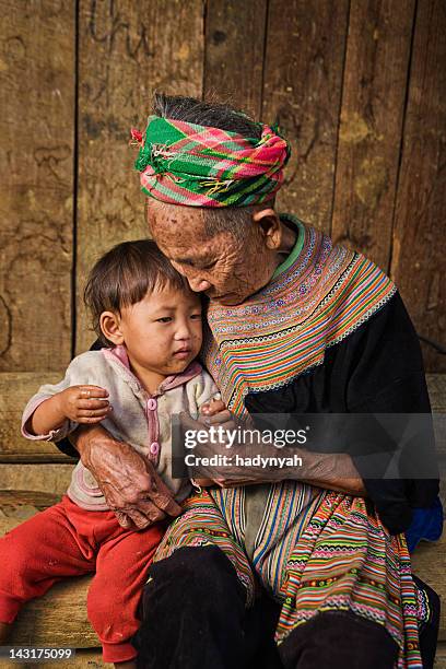 vietnamese grandmother from flower hmong tribe with her granddaughter - hmong stockfoto's en -beelden