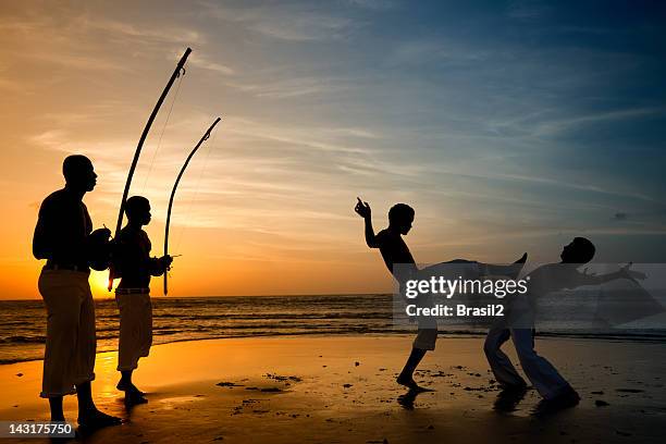 capoeira and berimbau player - brazilian music stock pictures, royalty-free photos & images