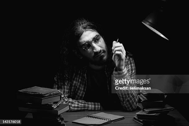 poet writing on table in the dark - poet stock pictures, royalty-free photos & images