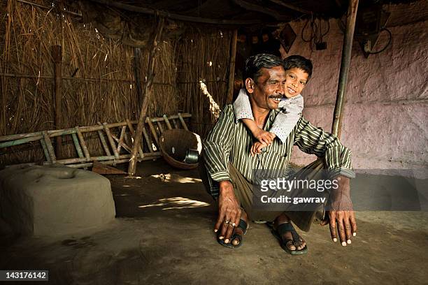 real people from rural india: happy father and son - the project portraits stock pictures, royalty-free photos & images