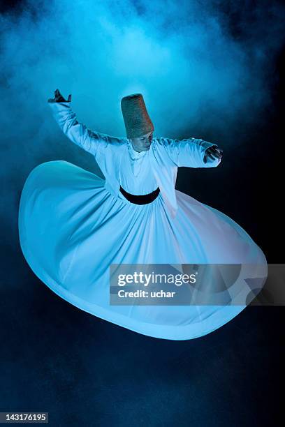 dervish spinning in white from above on black background - soefisme stockfoto's en -beelden