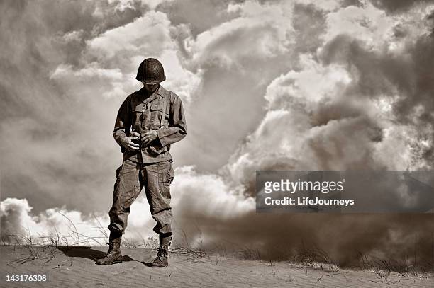 war weary wwii soldier during a retrospective moment - army soldier stockfoto's en -beelden