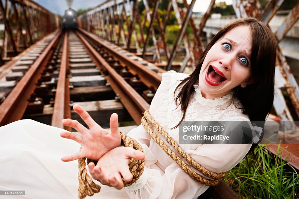 Victorian maiden tied to train tracks screams as engine approaches