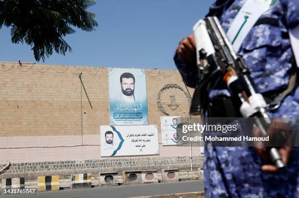 Soldiers recruited by the Houthi group stand guard while people attend a celebration to commemorate the birthday of the Prophet Muhammad on October...