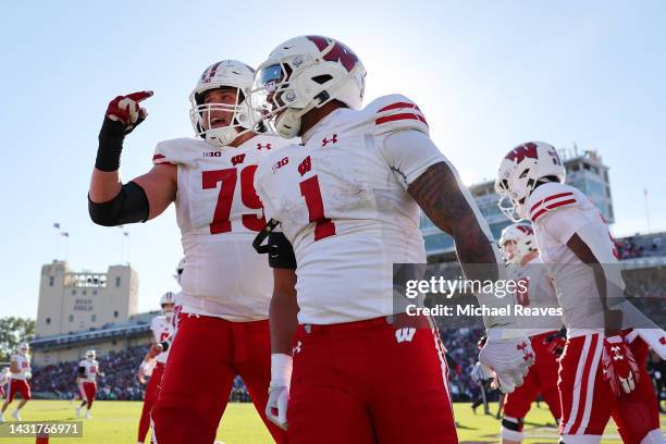 Chez Mellusi of the Wisconsin Badgers celebrates a touchdown reception against the Northwestern Wildcats during the first half at Ryan Field on...