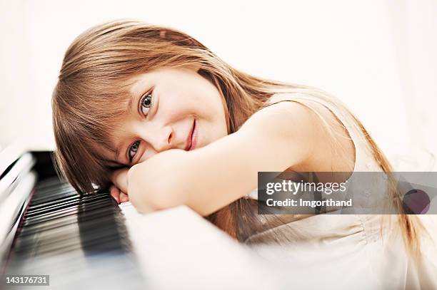 little girl and her piano - pianist stock pictures, royalty-free photos & images